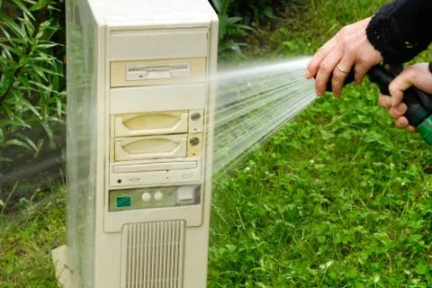 Cleaning old dirty computer tower. Person washing vintage computer in gargen Stock Photos