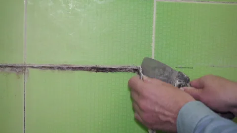 Cleaning old silicone on a tile Stock Footage 322174291