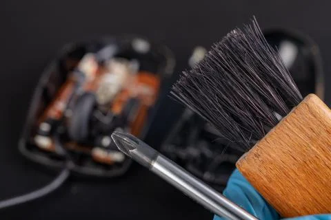 Cleaning of an optical computer mouse with a brush. Keeping the computer work Stock Photos