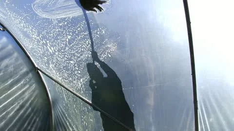 Cleaning the outside of a polytunnel Stock-Footage 12306024