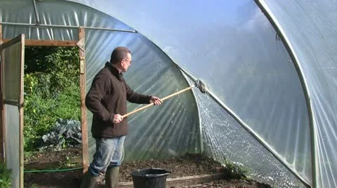 Cleaning the outside of a polytunnel Stock Footage 12307588