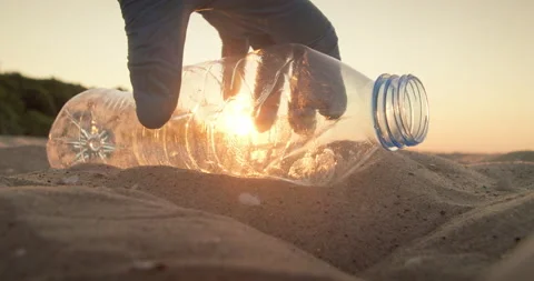 Cleaning plastic from the beach. Close-up of a plastic bottle. Stock Footage 171858316
