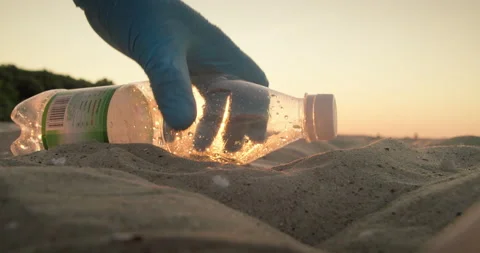 Cleaning plastic from the sandy beach at sunset. Stock Footage 175185279