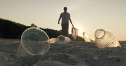 Cleaning plastic from the sandy beach at sunset. Stock Footage 175191740