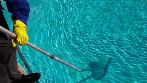 Cleaning the pool from debris with a special mesh. Maintenance of the pool Stock Footage 220918152