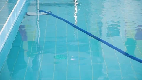 Cleaning the pool. A man cleans the pool. Stock Footage 253666853