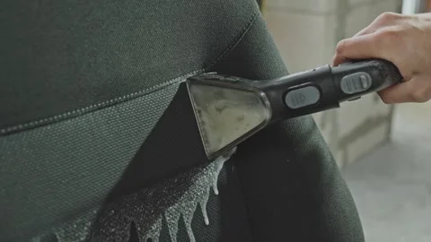 Cleaning process of car seat, removing dirt using washing vacuum cleaner. Video stock 319442592