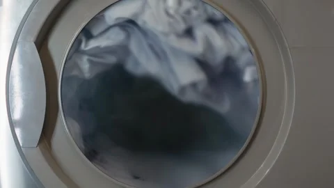 Cleaning process. The interior of a washing machine is filled with various Stock Footage 326248647