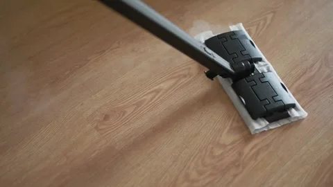 Cleaning process with a steam mop gliding over wooden floor Stock Footage 318795178