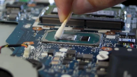 Cleaning the processor crystal with a cotton swab soaked in alcohol. Wipes off Stock Footage 297071586
