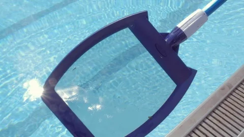Cleaning a Public Swimming Pool with a Mesh Skimmer Stock Footage 114635376