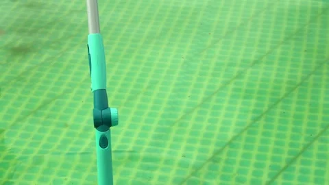 Cleaning pvc inflatable swimming pool, Cleaning the dirty empty pool of algae Stock Footage 137543209