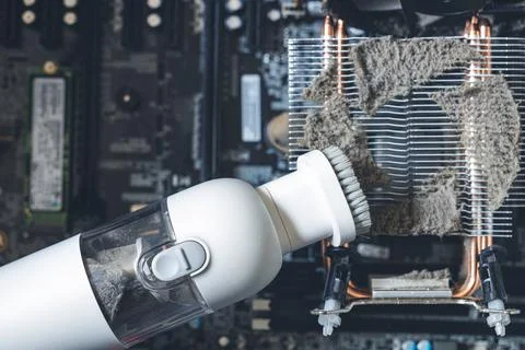 Cleaning the radiator in the computer system unit, removing dirt in the compu Stock Photos