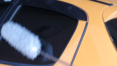 Cleaning Rear Car Window with Microfiber Duster Stock Footage 336959559