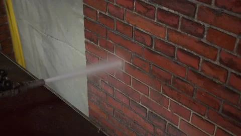 Cleaning a red brick wall using a water Pressure Washer. Stock Footage 196022026