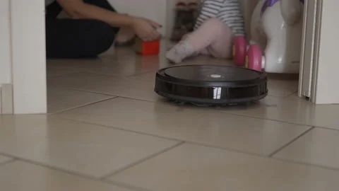 Cleaning robot does housework meanwhile mother plays with her child Stock Footage 143654328