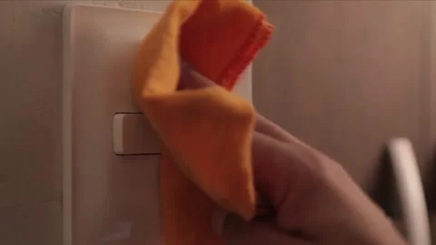 Cleaning the room light switch Stock Footage 158262590