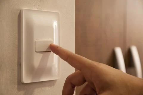 Cleaning the room light switch.. Stock Photos