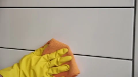Cleaning the room, wipe the white surface with yellow gloves and a orange rag. Stock Footage 131265517