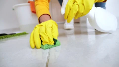 Cleaning the room, wipe the white surface with yellow gloves and a orange rag. Stock Footage 131469676