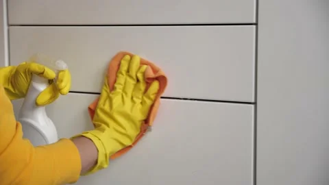 Cleaning the room, wipe the white surface with yellow gloves and a orange rag. Stock Footage 133694608