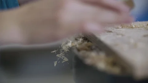 Cleaning off sawdust from a plank Stockbeeldmateriaal 92671864