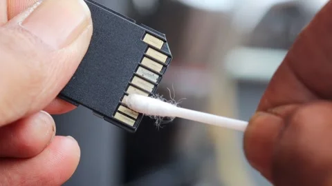 Cleaning SD memory card contacts using a cotton swab Stock Footage 345650680