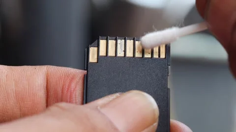 Cleaning SD memory card contacts using a cotton swab Stock Footage 345650684
