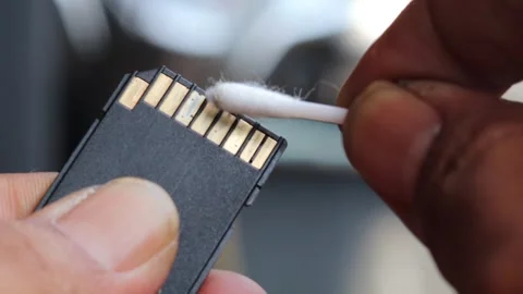 Cleaning SD memory card contacts using a cotton swab Stock Footage 345650730