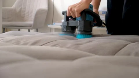 Cleaning service maid worker using electric brush machine cleaning sofa. Stock Footage 311798680