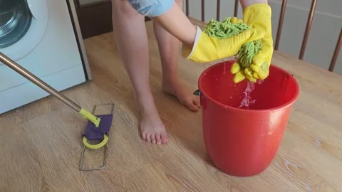 Cleaning service worker puts on rubber gloves, preparing for a thorough cleaning Stock Footage 301868416