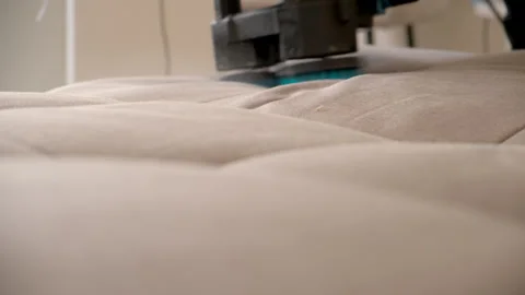 Cleaning service worker removing stains from sofa using electric brush. Stock Footage 311798628