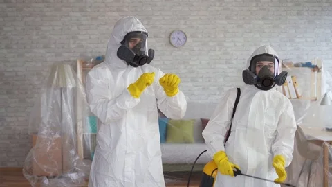 Cleaning service workers or scientists in protective overalls dancing Video stock 105549228