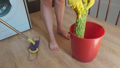 Cleaning services in action, a person pulls a cloth from the bucket and wrings i Stock Footage 301868433