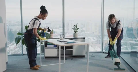 Cleaning services. Afro-american young woman tidying up computer desk while her Stock Footage 149263522