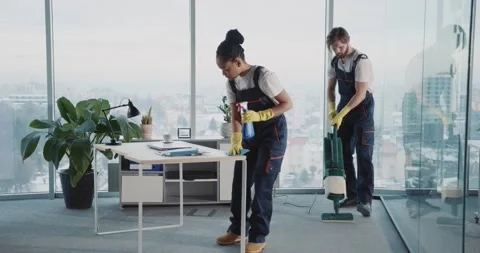 Cleaning Services. Multi-ethnic Couple of Janitors Weqaring Blue Uniform Stock Footage 149263451