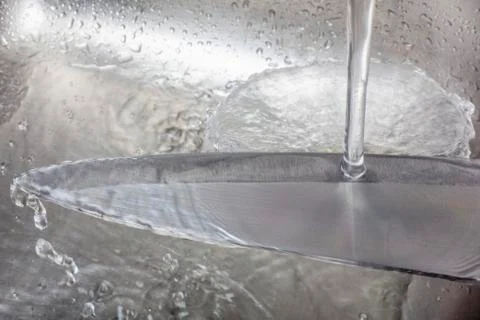 Cleaning a sharp knife Stock Photos