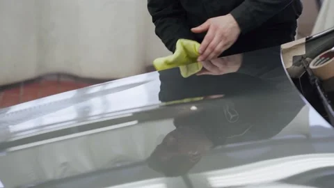 Cleaning to shine. Professional work, Professional car washer wipes the car Stock Footage 150917092