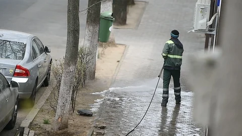 Cleaning the sidewalk with high pressure solution during coronavirus 스톡 동영상 127692978