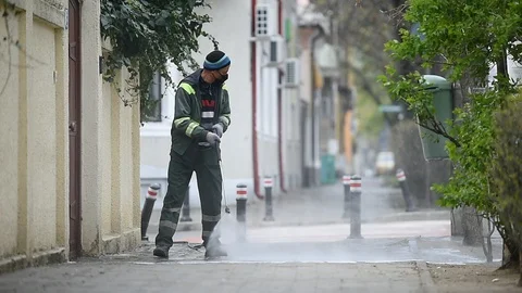 Cleaning the sidewalk with high pressure solution during coronavirus 스톡 동영상 127693060