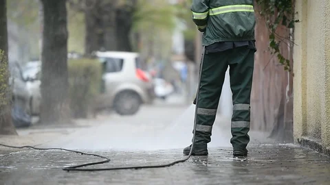 Cleaning the sidewalk with high pressure solution during coronavirus Video stock 127693082
