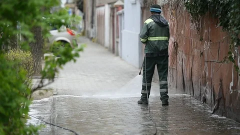 Cleaning the sidewalk with high pressure solution during coronavirus 스톡 동영상 127693125