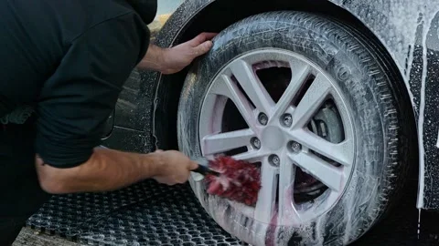 Cleaning silver alloy wheels with snow foam shampoo and iron removing using a Stock Footage 318437688