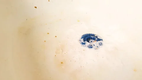 Cleaning the sink with detergent while wearing gloves. Cleaning the kitchen sink Stock Footage 312457201