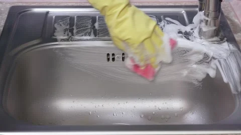 Cleaning the sink with a pink sponge Stock-Footage 310539593