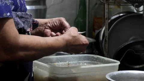Cleaning small fish anchovy, side view Stock Footage 252868489