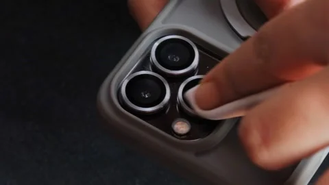 Cleaning a smartphone camera lens 스톡 동영상 339329349