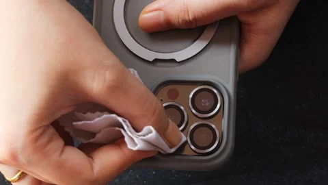 Cleaning a smartphone camera lens Video stock 339329350