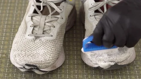Cleaning sneakers with brush and soap close up Video stock 231724853