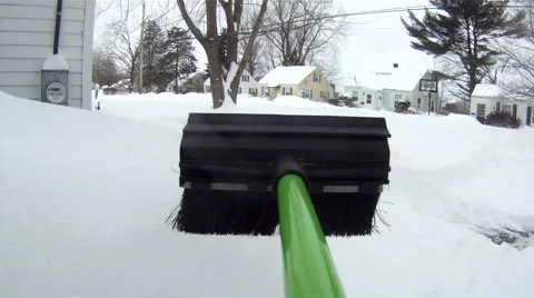 Cleaning snow off car with brush - point of view Stock Footage 47010668